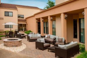 a patio with couches and chairs and a fire pit at Courtyard by Marriott Rockville in Rockville