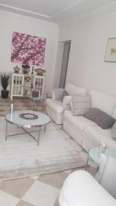 a living room with a couch and a table at Riyadh, King Faisal District Apartment in Riyadh