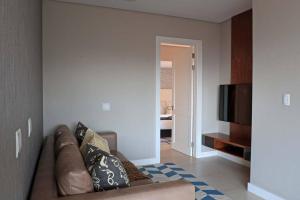 a living room with a couch and a flat screen tv at Luxury Zimbali Villa*7 Grandview*Seaview*Pool* in Ballito