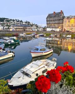 a group of boats docked in a harbor with red flowers at Home in Dartmouth, Devon with Private Parking in Dartmouth