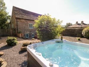 a hot tub in the backyard of a house at The Barn in Bishop Auckland