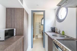 a kitchen with a sink and a microwave at Small private house 4P1BR - Marseille 8th in Marseille