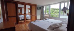 A bed or beds in a room at Apartamentos El Jornu