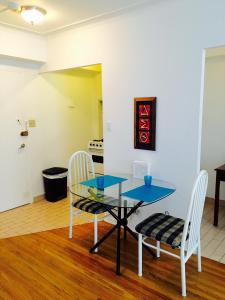 a dining room with a glass table and two chairs at Stylish Montreal Apartment: Comfortable Stay in the Golden Square Mile in Montreal