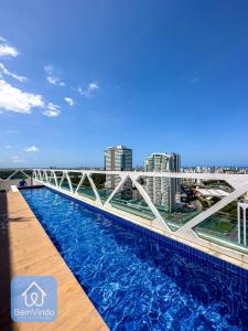 a bridge over a swimming pool on top of a building at Apartamento em frente ao Salvador Shopping in Salvador