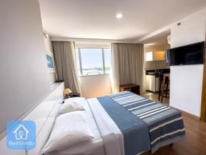 a hotel room with a bed and a kitchen at Apartamento em frente ao Salvador Shopping in Salvador