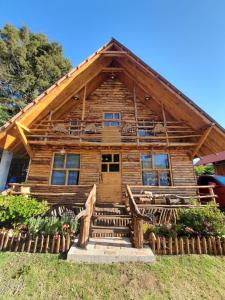 a log cabin with stairs in front of it at Cabañas La Palma in Mineral de Angangueo