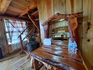 a wooden room with a table with bottles on it at Cabañas La Palma in Mineral de Angangueo