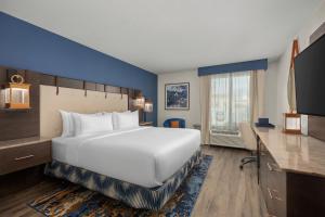 a hotel room with a large white bed and a desk at Hotel Westport Kansas City, Tapestry Collection by Hilton in Kansas City +59 photos
