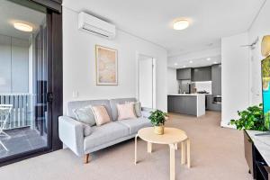 un soggiorno con divano e tavolo di New Amazing Park City high level APT a Sydney