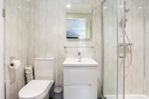 a bathroom with a toilet and a sink and a shower at The Secret, Stylish & Spacious En Suite in Blandford Forum, Dorset in Blandford Forum
