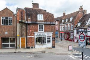 an old brick building on a city street at The Secret, Stylish & Spacious En Suite in Blandford Forum, Dorset in Blandford Forum