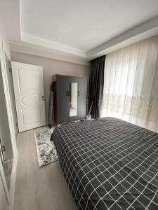 a bedroom with a bed and a window and a door at 2+1 SÜPER EŞYALI KİRALIK DAİRE in Dalaman