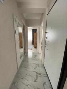 a hallway with a mirror and a long hallway with white walls at 2+1 SÜPER EŞYALI KİRALIK DAİRE in Dalaman