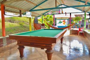 a pool table with a hammock in a house at Casa del Bosque in Trujillo