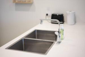 a kitchen sink in a counter top with a sink at Superior View APT in heart of Sydney Olympic Park in Sydney