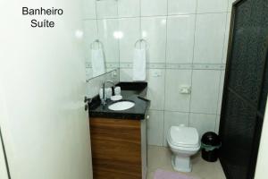 a bathroom with a sink and a toilet at Casa na Fronteira in Foz do Iguaçu