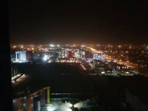 a view of a city at night with lights at Skyview Apartments in Gaborone