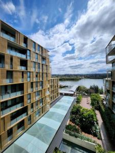 an apartment building with a view of a body of water at Luxury 2 bedroom APT in Wentworth Point in Sydney