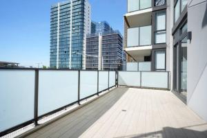 a balcony with a view of some tall buildings at Stunning 2 bedroom APT in Wentworth point in Sydney