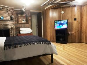 a room with a bed and a tv in it at Maria Montreal in Montreal