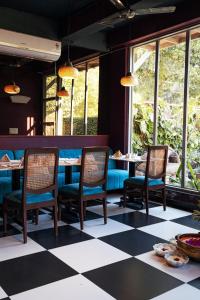 a restaurant with chairs and a checkered floor at Ekaa Villa near Taj Mahal in Agra