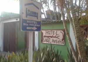 a sign for a hotelsta helena next to a building at Hotel Santa Helena in Leticia