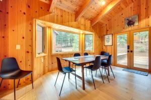 a dining room with a table and chairs in a cabin at 5 Mi to Donner Lake Cabin with Deck and Pool Access! in Truckee