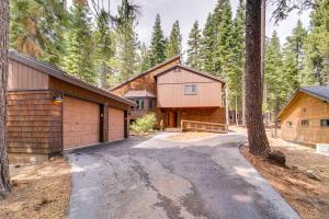 a driveway leading to a house with a garage at 5 Mi to Donner Lake Cabin with Deck and Pool Access! in Truckee