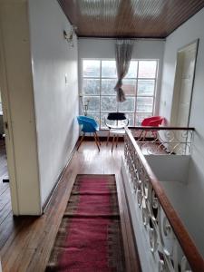 a room with a staircase with a red rug at Casa en Bogotá ubicada en zona central in Bogotá