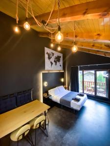 a bedroom with a bed and a wooden table at Modern Black Studio Penthouse En Valle De Incles - Parking Gratis in Canillo