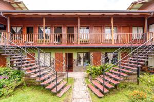 a building with stairs leading up to a balcony at Pension Santa Elena in Monteverde Costa Rica