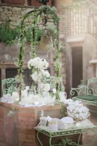 a table with white dishes and flowers on it at Hotel Canasta in Capri