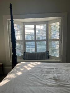 a bedroom with a bed and a large window at The Ellery Hotel in Provincetown