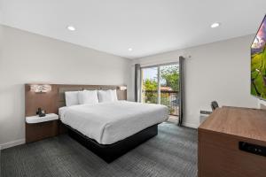 a hotel room with a bed and a window at Cedar Street Hotel & Suites in Sandpoint +65 photos