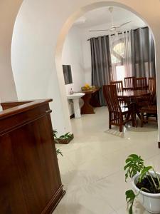 a room with a table and chairs and a dining room at GOLDEN TASTE REST HOUSE in Dar es Salaam