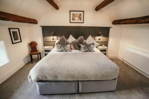 a bedroom with a large bed and two tables at Sledbank Cottage in the Hill, Silecroft in Silecroft