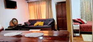 a living room with a couch and a table at CASA ZONA CASINO, SUPERMERCADO. TODAS LAS COMODIDADES in Eldorado