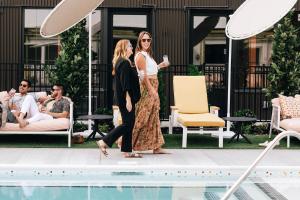 two women walking by a swimming pool at The Myriad Hotel in Louisville