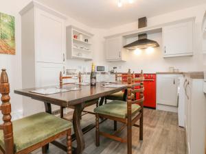 a kitchen with a dining room table and chairs at 3 Tindale Terrace in Brampton