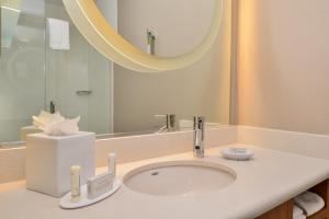 a bathroom with a sink and a mirror at SpringHill Suites Irvine John Wayne Airport / Orange County in Irvine