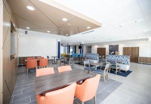 a conference room with a wooden table and chairs at Holiday Inn Express & Suites Tampa Stadium - Airport Area, an IHG Hotel in Tampa