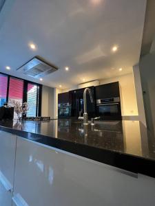 a kitchen with a black counter top with a microwave at The coffee Corner Nuenen/Eindhoven in Nuenen