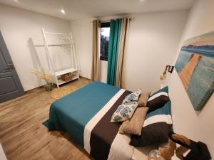 a bedroom with a bed and a window at Au Doux Refuge 2 in Le Lambert