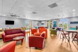 a waiting room with chairs and tables and a tv at Port of the Islands M258 in Naples