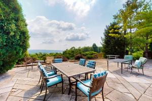 a patio with a wooden table and chairs at Scenic View Lodge - Entire Property in Bloomington