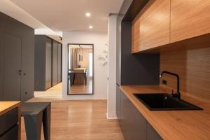 a kitchen with a sink and a counter top at Sauna&Jacuzzi Apartment in Cluj-Napoca