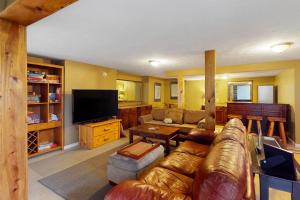 a living room with a couch and a tv at Scenic View Lodge - Entire Property in Bloomington