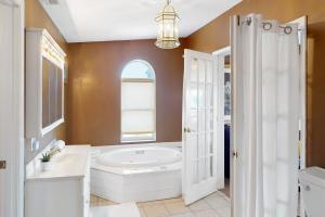 a bathroom with a large tub and a window at Scenic View Lodge - Entire Property in Bloomington