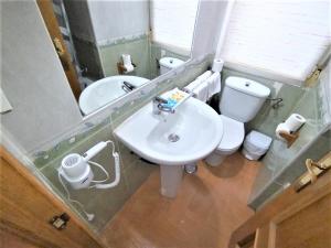 a bathroom with a sink and a toilet and a mirror at Apartamento - Puerta del Sol in Madrid